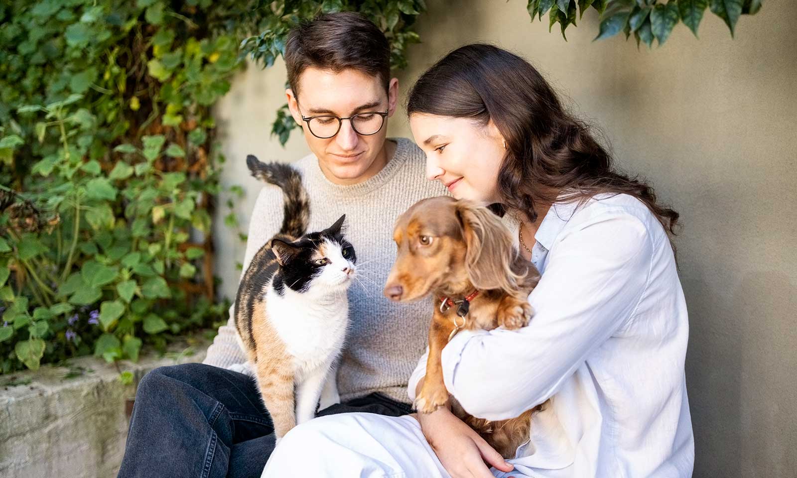 A cat and dog with their family